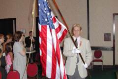 Jonathan-Hicks-bringing-US-flag-into-business-meeting